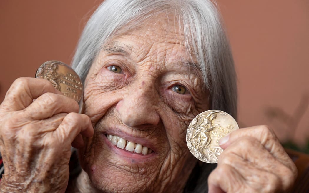 Hungarian-Israeli retired Olympic and world champion artistic gymnast Agnes Keleti shows a gold medal won during the Olympic Games in Helsinki 1952 and another one won in Melbourne 1956. 2020.