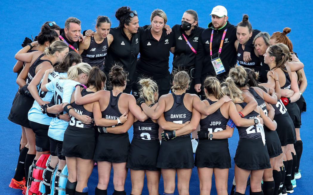 New Zealand Black Sticks team huddle as England celebrate winning the England v New Zealand Black Sticks Women's Hockey Semi Final at the University of Birmingham Hockey and Squash Centre, Birmingham, England on Friday 5 August 2022.
Birmingham 2022 Commonwealth Games.
Mandatory credit: Matthew Impey / www.photosport.nz