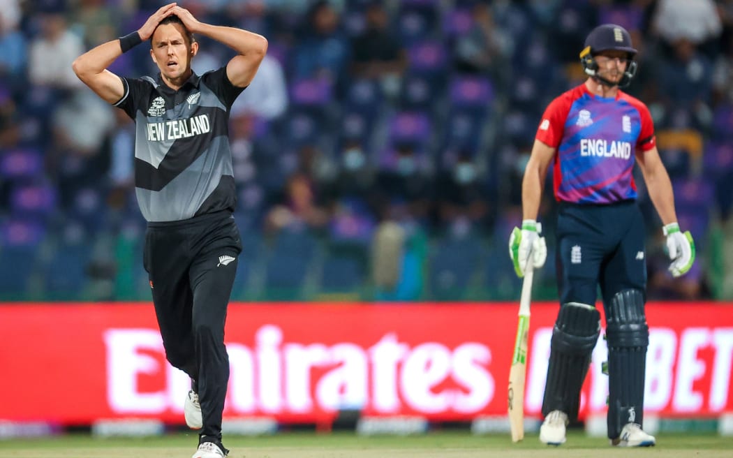 Trent Boult (L) from the New Zealand BlackCaps reacts after being hit for a boundary by Jos Buttler of England during the ICC Men's T20 World Cup semifinal between New Zealand and England at Sheikh Zayed Cricket Stadium, Abu Dhabi, UAE on Wednesday 10th November 2021.