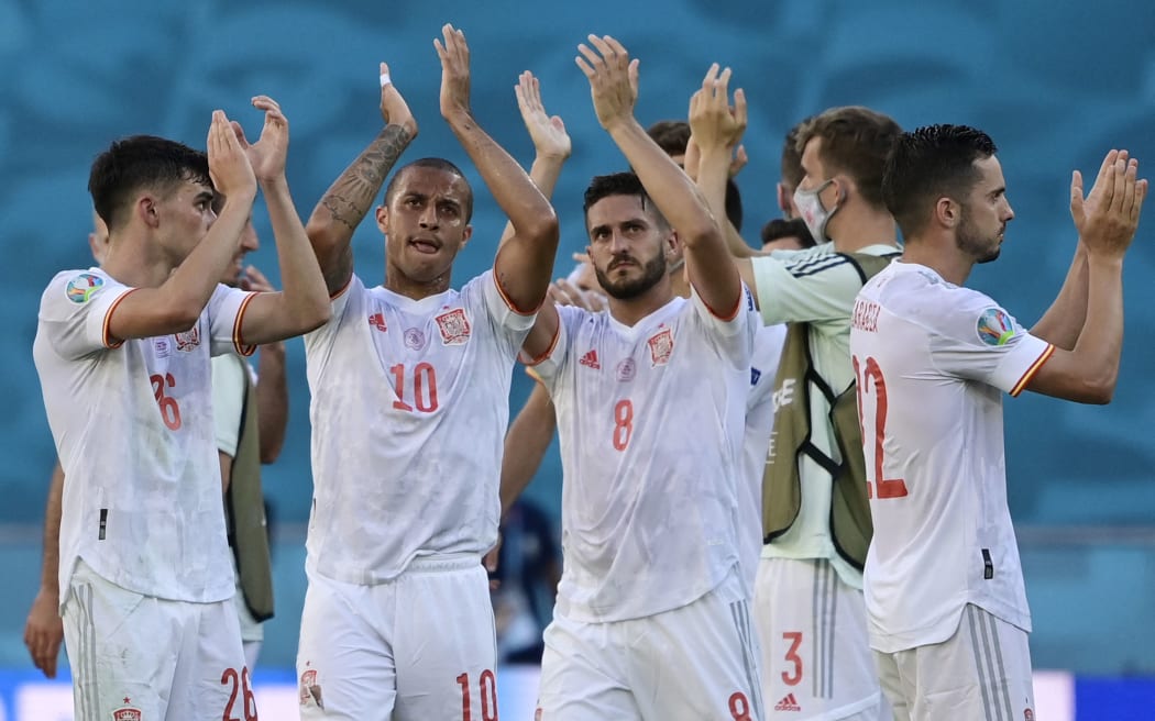 Spain's players celebrate their victory after the EURO 2020 Group E football match against Slovakia at La Cartuja Stadium in Seville on June 23, 2021.
