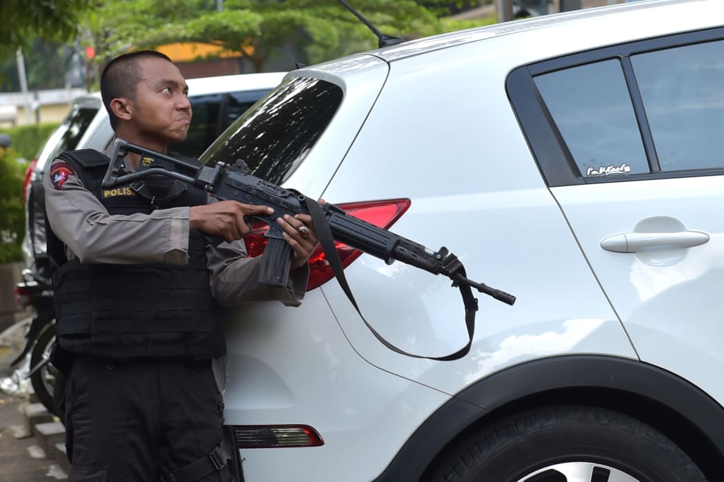 An anti-terror police officer stands guard near Starbucks, where the attack occurred.