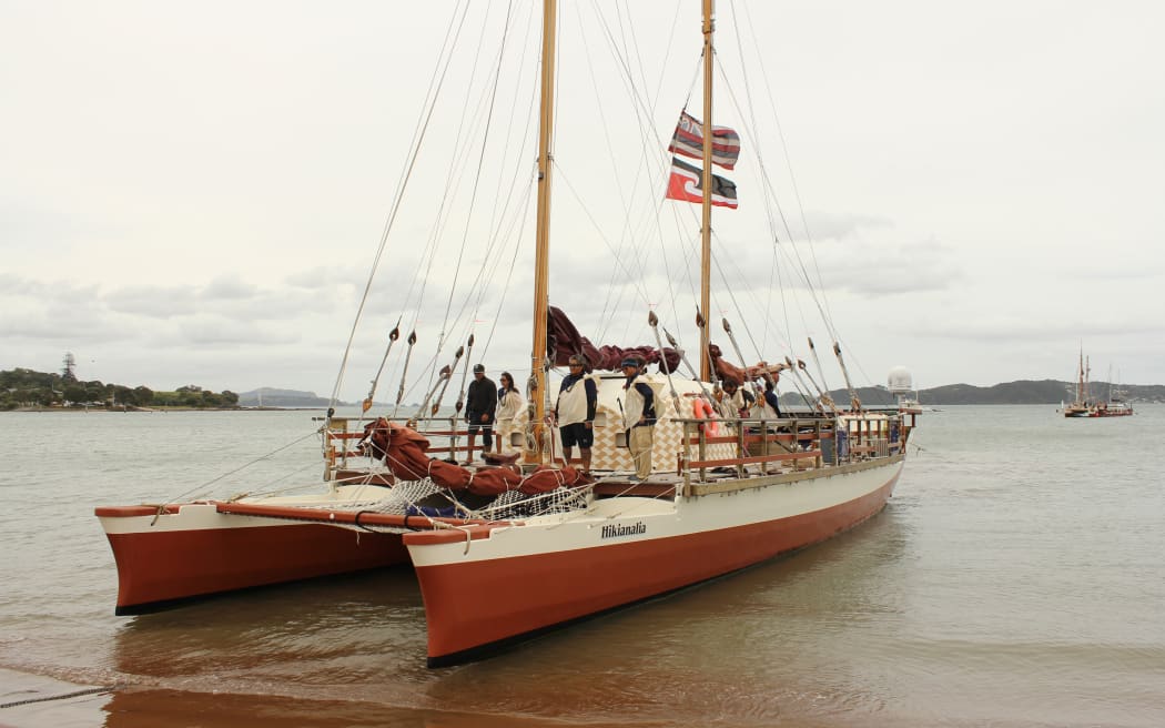 Hikianalia, with Hōkūleʻa in the distance, lands at Waitangi during the 2014 voyage.