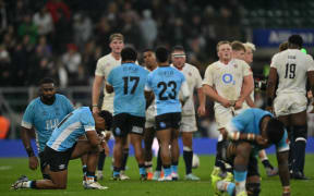 Players react on the field after the Autumn Nations Series international rugby union match between England and Fiji at Allianz Stadium, Twickenham, in south-west London, on November 8, 2025. England won the game 38-18. (Photo by Glyn KIRK / AFP)