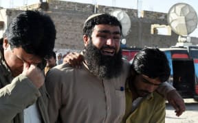 Pakistani relatives mourn the loss of family members after the attack in Quetta.