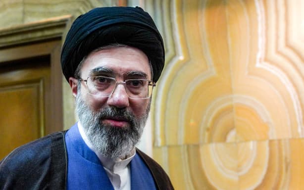 (FILES) In this picture obtained from Iran's ISNA news agency, Mojtaba Khamenei, son of Iran's supreme leader Ayatollah Ali Khamenei, looks on in Tehran on October 13, 2024. Iran marked the appointment of Ayatollah Mojtaba Khamenei to replace his father as its supreme leader with a new barrage of missiles against Israel and the Gulf states on March 9, 2026, as the Middle East war sent oil prices soaring.