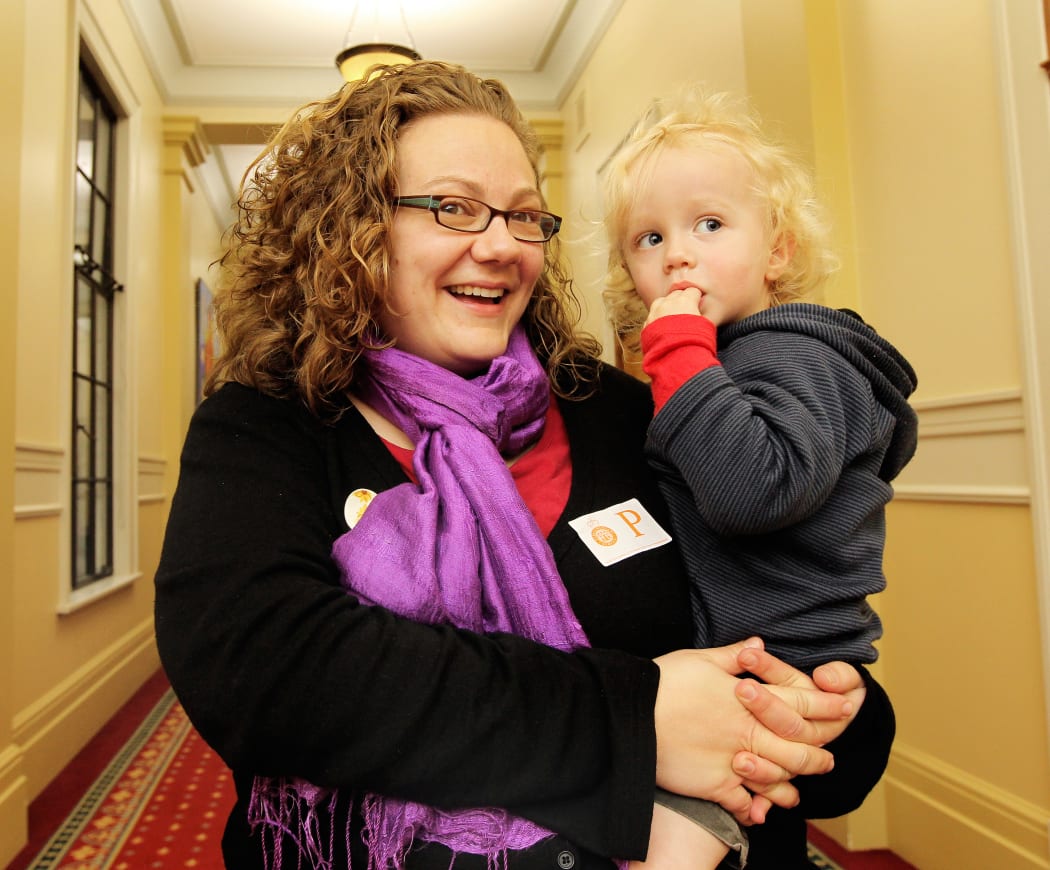 Huia Welton holds her infant son.