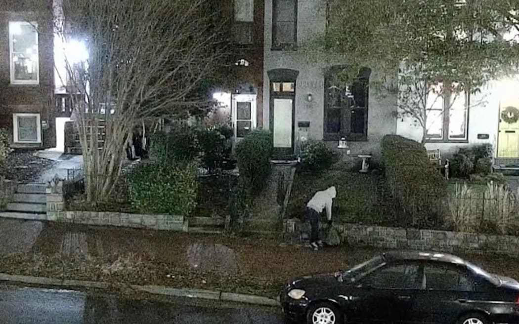 This still from video from the FBI shows the person who placed two viable pipe bombs near the Republican and Democratic National Committee headquarters in Washington, DC in January 2021.