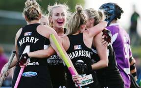 Samantha Harrison of New Zealand is mobbed by teammates after scoring a goal.