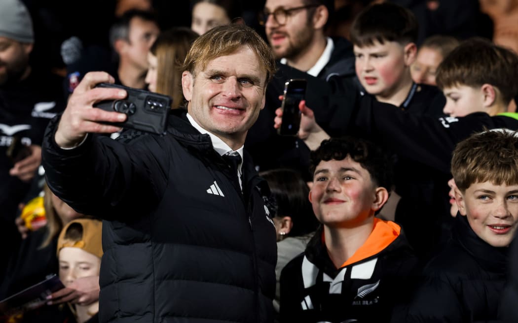 All Blacks coach Scott Robertson takes a selfie with fans.