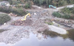 An aerial shot shows initial emergency remedial works in the days following the June 2023 slip that washed out part of Wilmott Pass Road in Fiordland.