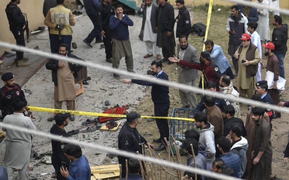Security personnel and locals gather at a blast site inside a mosque in Islamabad on February 6, 2026.