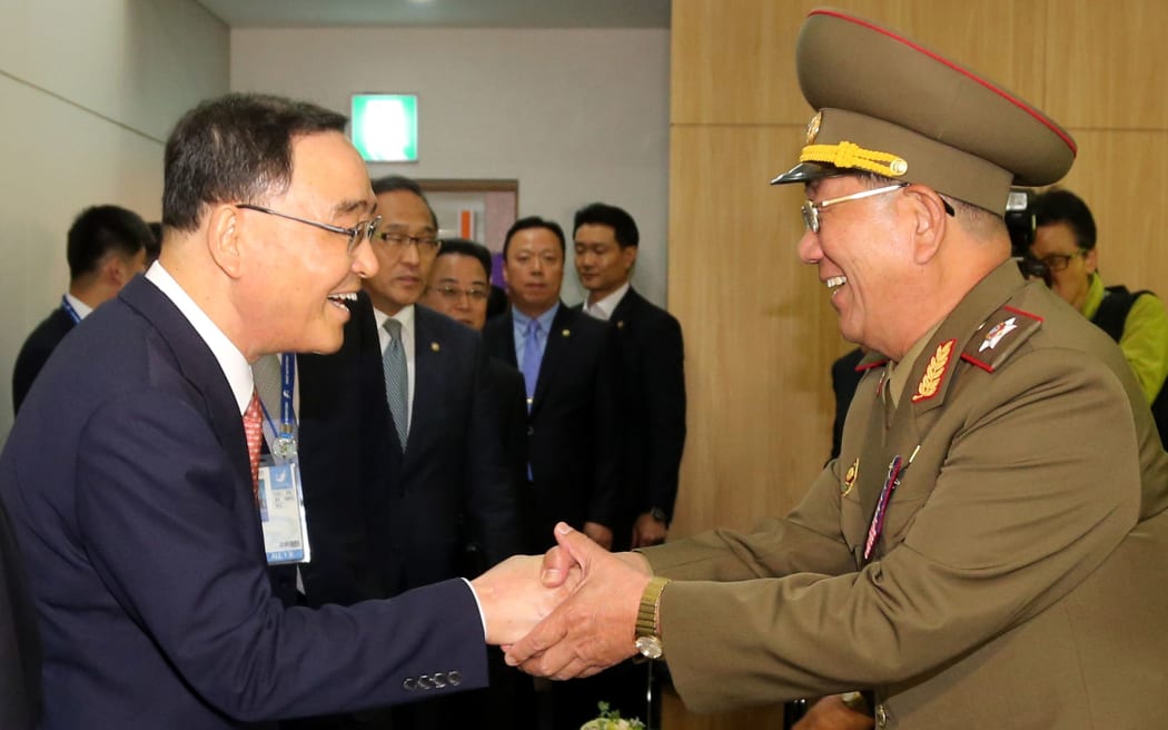 South Korean Prime Minister Chung Hong-Won (L) shakes hands with Hwang Pyong-So - director of the North Korea military's General Political Bureau.