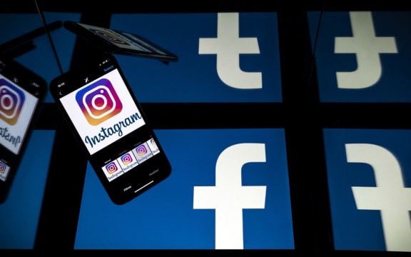 (FILES) this file photo taken on October 05, 2020 in Toulouse, southwestern France, shows logos of US social networks Facebook and Instagram on the screens of a tablet and a mobile phone.