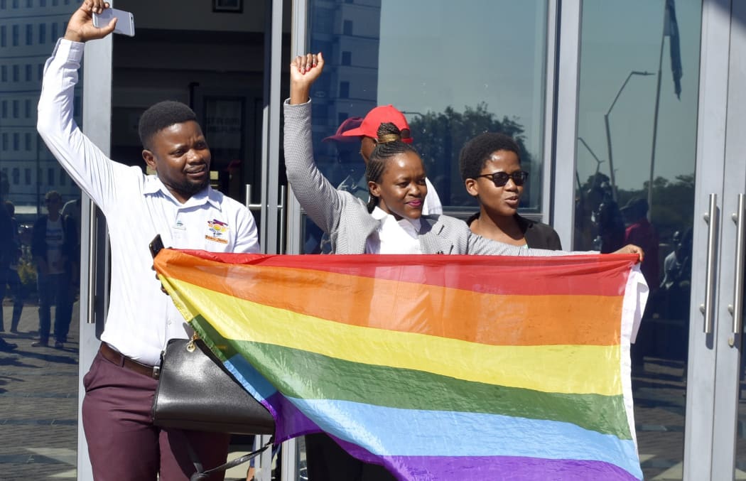 Activists celebrate outside the High Court in Gaborone, Botswana, Tuesday June 11, 2019. Botswana became the latest country to decriminalize gay sex