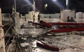 Emergency teams stand next to a construction crane after it crashed into the Grand Mosque of Saudi Arabia's holy Muslim city of Mecca on 11 September 2015.