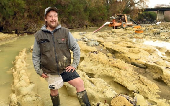 Michael Johnston at the riverbed site where preparations are being made to remove the the fossilised moa footprints he discovered.