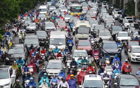 Motorists in morning rush hour traffic in Hanoi on 12 May.