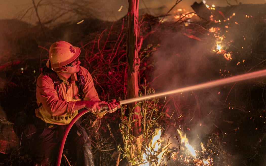 A firefighter at the Maria Fire, which exploded to 8000 acres on its first night, on 1 November 2019 near Somis, California.