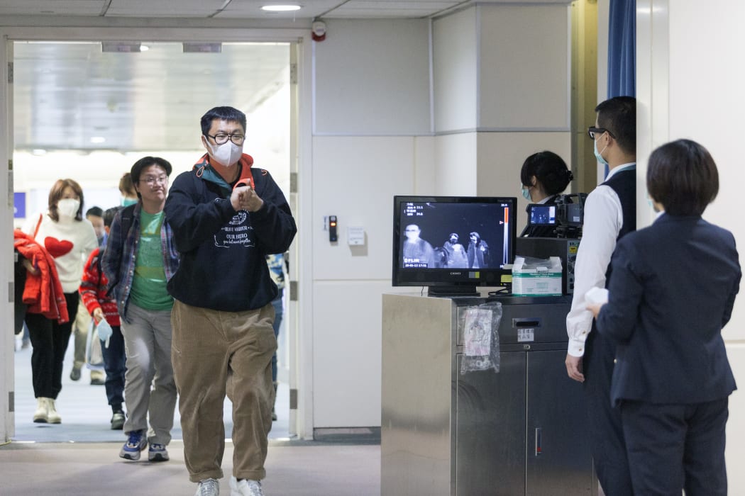 Taiwan's Center for Disease Control personnel using thermal scanners to screen passengers arriving on a flight earlier this year.