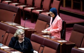 Newly-elected Labor Senator Fatima Payman (R), the first Afghan-Australian Muslim woman in Parliament, attends a session in the Senate chamber during the opening of the 47th Parliament at Parliament House in Canberra on July 26, 2022. (Photo by AFP)