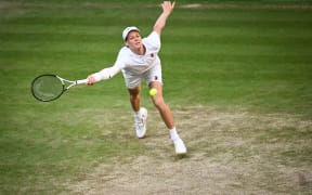 Italy's Jannik Sinner plays a forehand return to Serbia's Novak Djokovic during their men's singles semi-final tennis match on the twelfth day of the 2025 Wimbledon Championships at The All England Lawn Tennis and Croquet Club in Wimbledon, southwest London, on July 11, 2025. (Photo by Kirill KUDRYAVTSEV / AFP) / RESTRICTED TO EDITORIAL USE