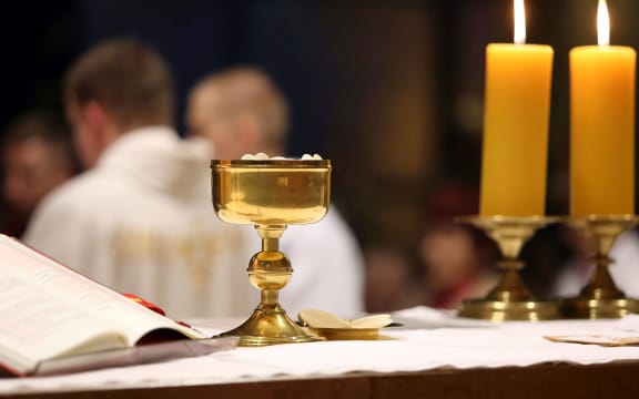 Golden chalice on the altar during the distribution of Holy Communion