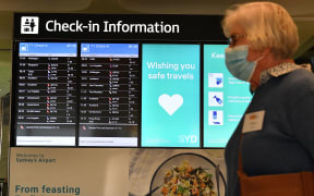 A woman proceeds to the check-in counter for New Zealand flights at Sydney International Airport on April 19, 2021, as Australia and New Zealand opened a trans-Tasman quarantine-free travel bubble.
