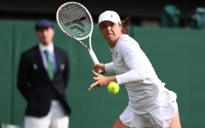 Polish tennis player Iga Swiatek in action at Wimbledon, 2024.