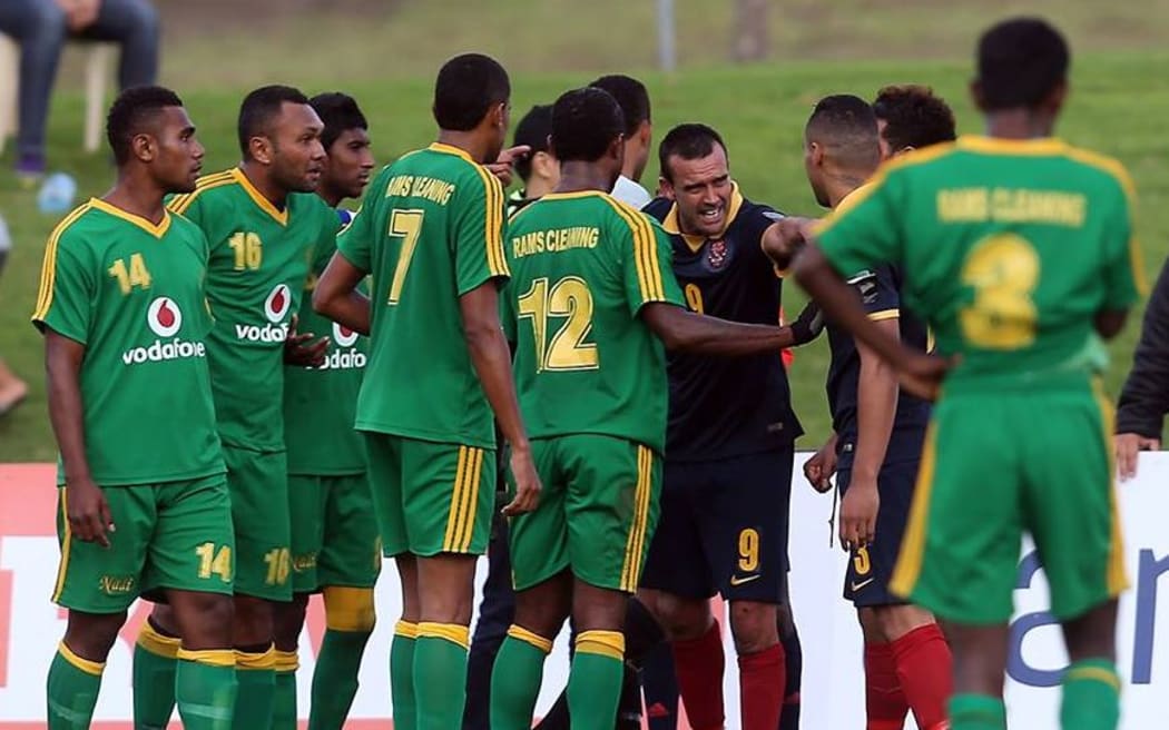 Kiwi FC captain Barry Lewis (9) and teammates scuffle with players from Nadi FA.