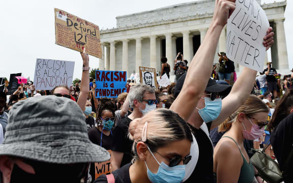 Demonstrators hold placards at the Lincoln Memorial during a peaceful protest against police brutality and racism, on June 6, 2020 in Washington, DC.