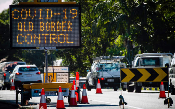 This file photo taken on April 15, 2020 shows a COVID-19 coronavirus sign at a Pacific Highway vehicle checkpoint on the Queensland-New South Wales state border near Coolangatta.