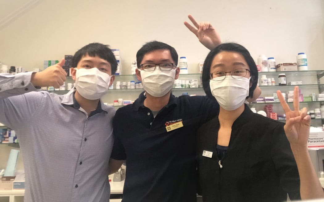Titus Jiang (middle) poses with his pharmacy colleagues in central Auckland during the first lockdown.