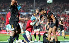Lions player Jack Nowell celebrates scoring their third try as Chiefs players gather themselves.