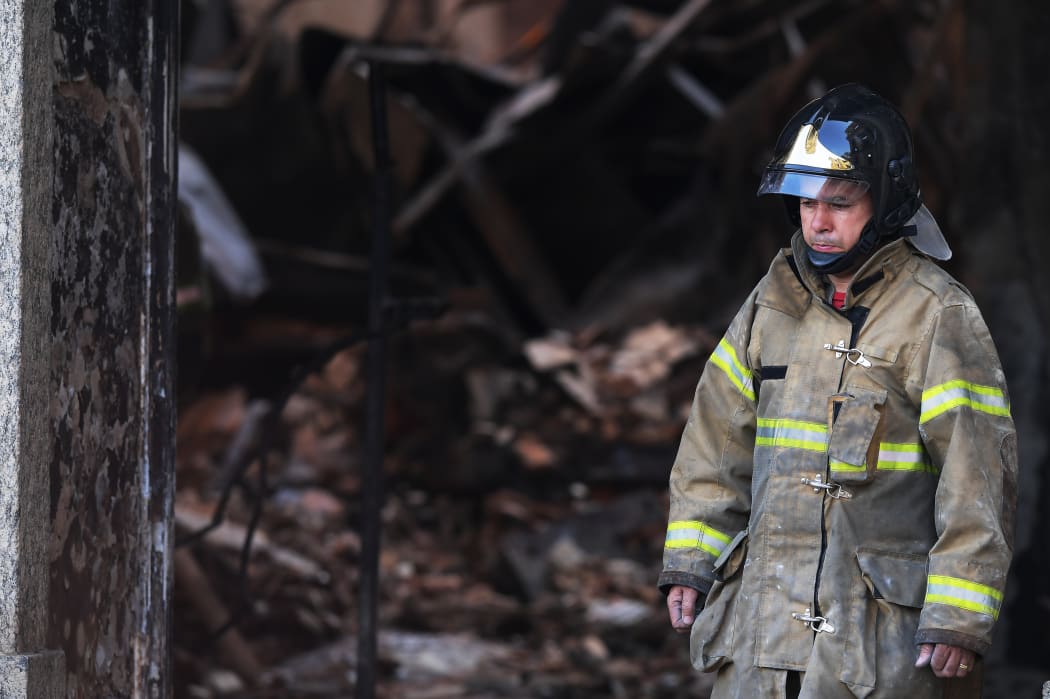 The majestic edifice stood engulfed in flames as plumes of smoke shot into the night sky, while firefighters battled to control the blaze that erupted.