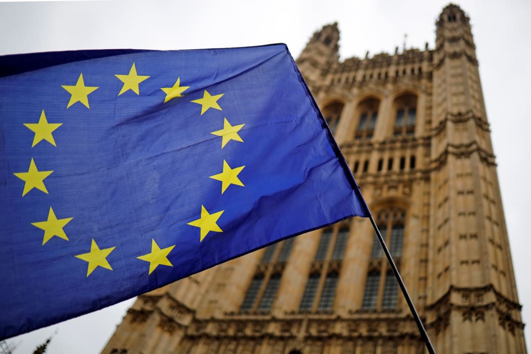 A European Union flag and belonging to an anti-Brexit activist flies outside the Houses of Parliament in London on October 23, 2019.