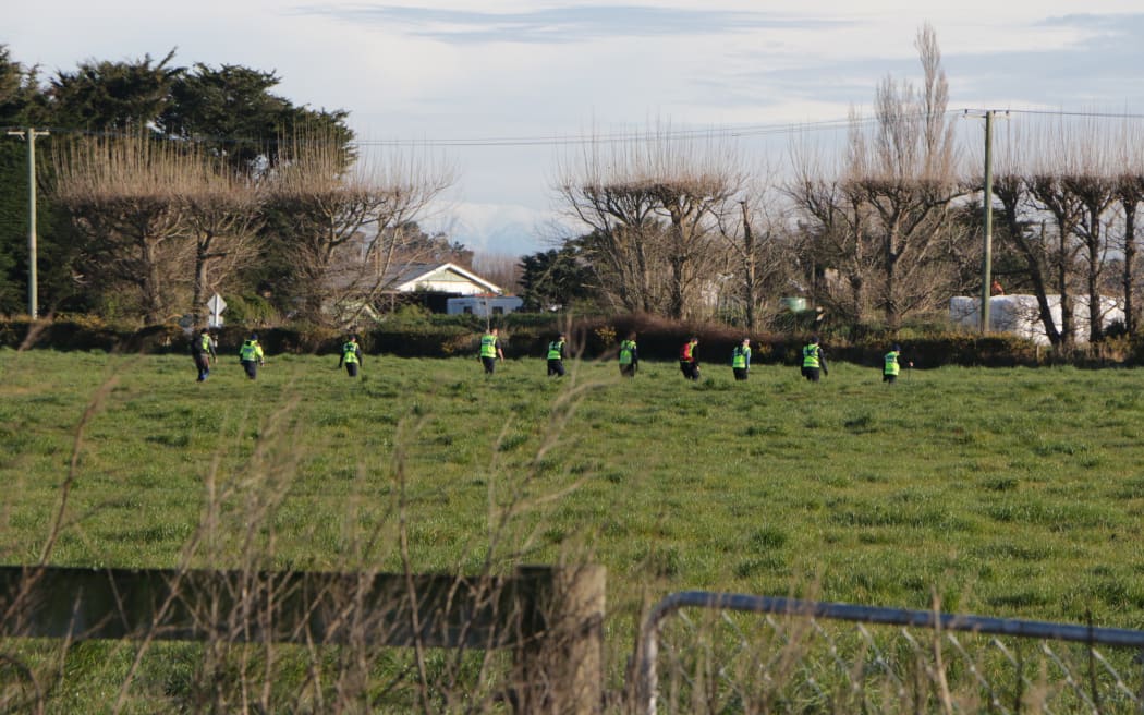 Police and search and rescue combing Greenpark farmland in Canterbury in connection to the homicide case.