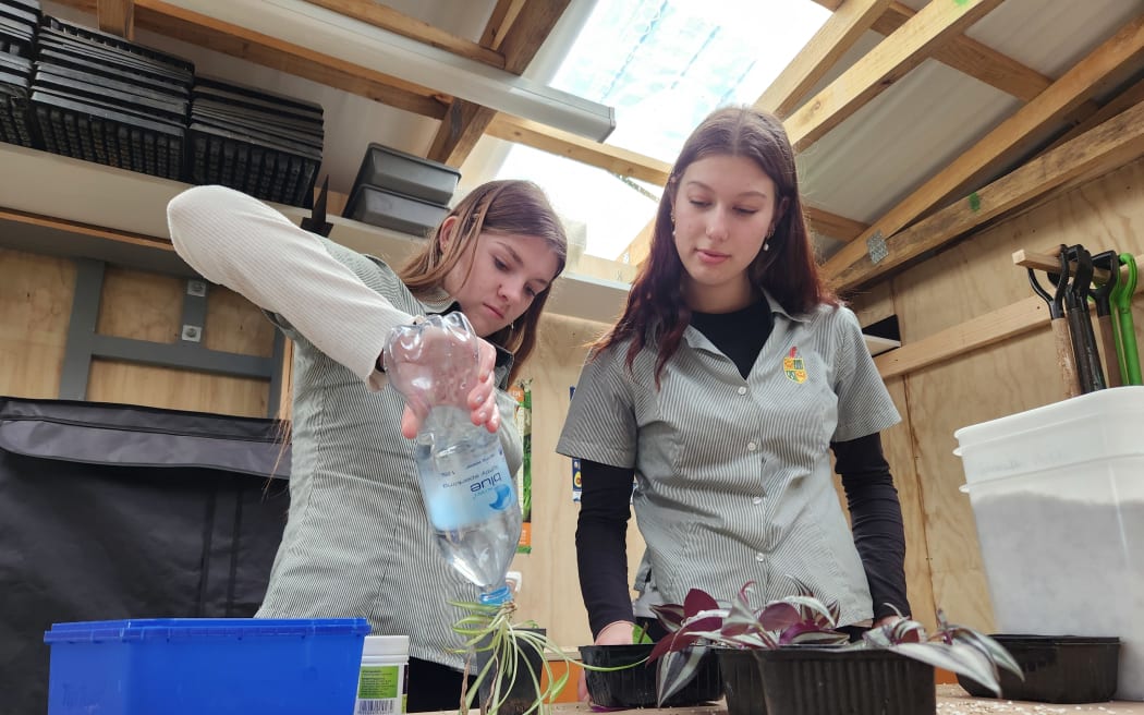 Kara McCormick and Millie Lochore at work in the potting shed