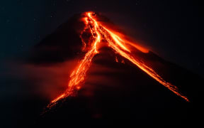 Lava and ashes flow from the Mayon Volcano which remains under alert level 3, in Daraga, Albay province, Philippines, on June 12, 2023. (Photo by Lisa Marie David/NurPhoto) (Photo by Lisa Marie David / NurPhoto / NurPhoto via AFP)
