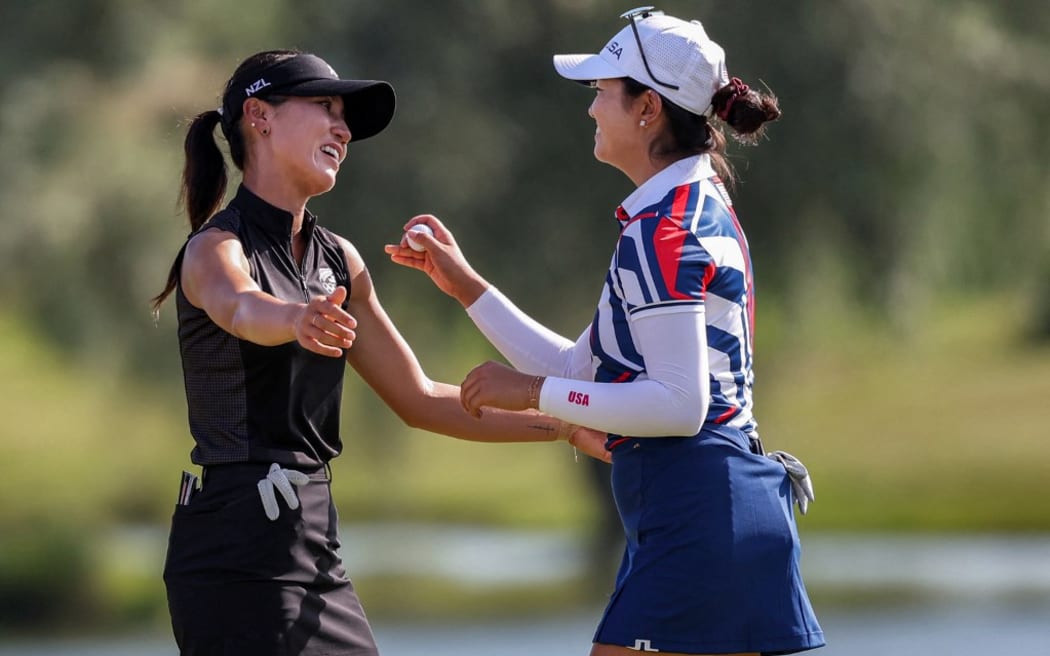 New Zealand's Lydia Ko celebrates winning the gold medal, with Rose Zhang of the US.