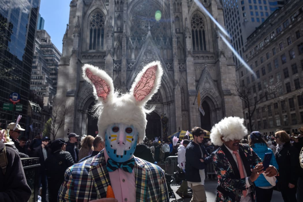 People stroll down New York City's 5th Avenue in the annual Easter Bonnet Parade, in front of St. Patrick's Cathedral.