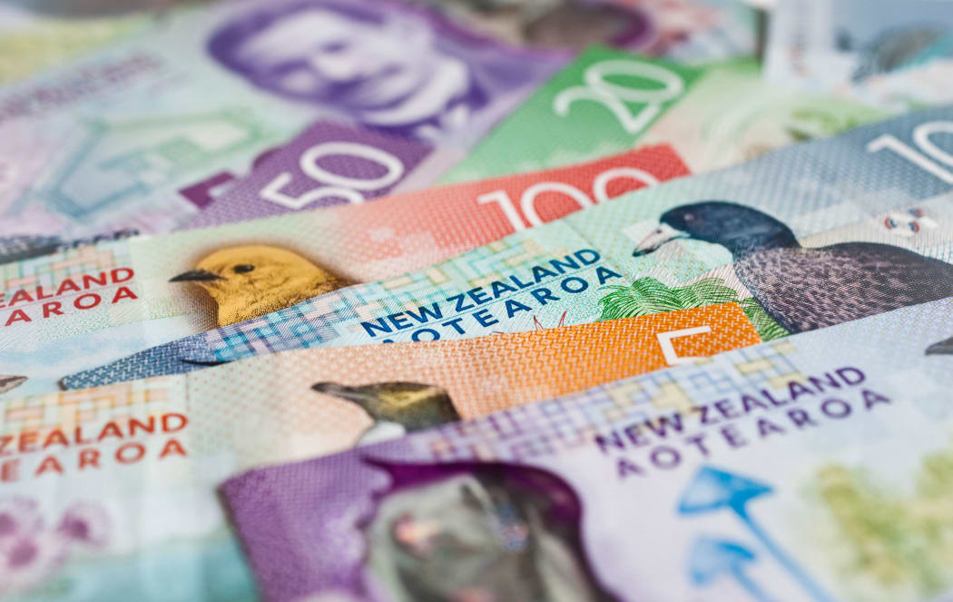 Pile of New Zealand currency laying flat on table