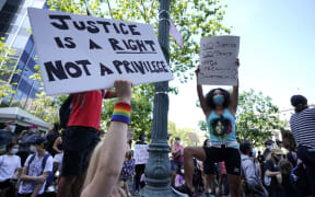 Protestors hold signs in New York City's Foley Square during a Juneteenth rally on 19 June.