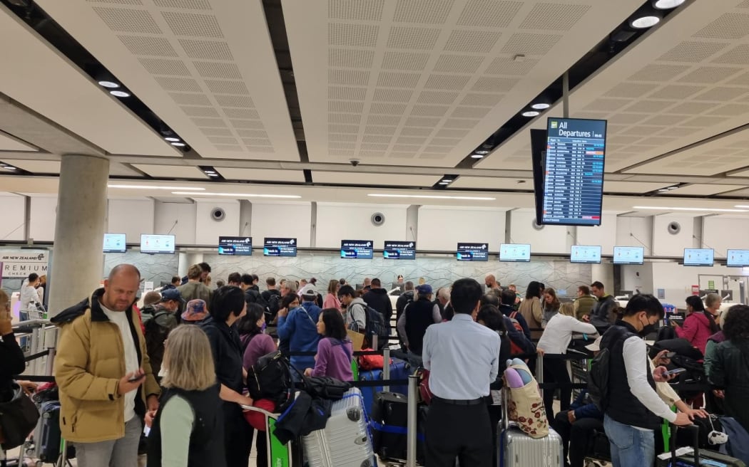 People queue to rebook flights at Christchurch Airport on 20 April 2024.