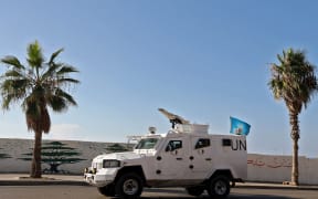 A UNIFIL armoured vehicle drives through Beirut as part of a UN peacekeeping convoy heading towards south Lebanon, on November 12, 2024, amid the ongoing war between Israel and Hezbollah. (Photo by PATRICK BAZ / AFP)