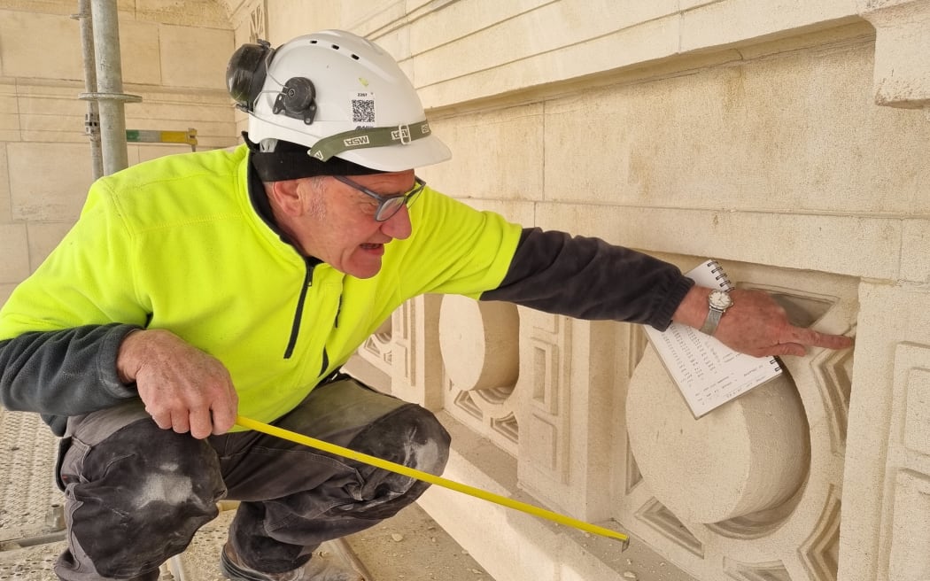 Mark Whyte examining an example of a 'banker' stonework on the Sarjeant Gallery facade, September 2023.