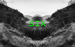 Podcast episode image for the 'Mr Lyttle Meets Mr Big' podcast. A moody black and white photograph of a misty country valley is mirrored vertically creating a Rorschach like effect with the episode number 'SIX' overlaid in vibrant green.