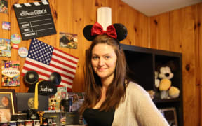 A portrait of Justine Conway wearing Disney paraphernalia
