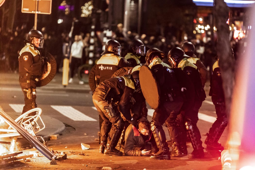 Police arrest a protester in Rotterdam.