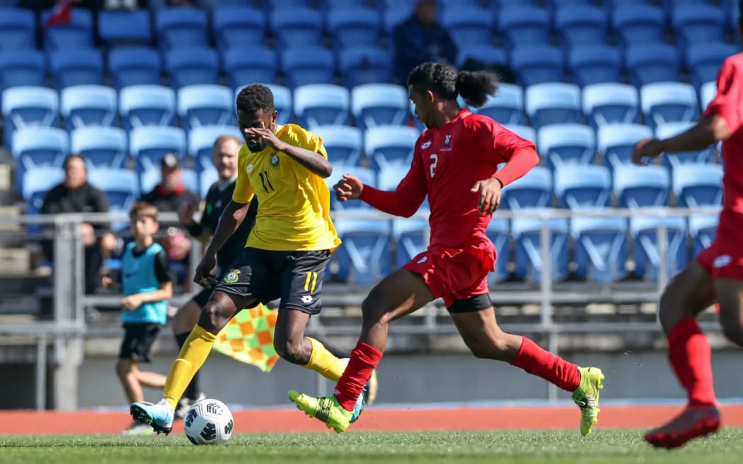 Vanuatu’s George Chichirua races past Tonga’s Kulisitofa Kite in the OFC Men’s Olympic Qualifier 2023