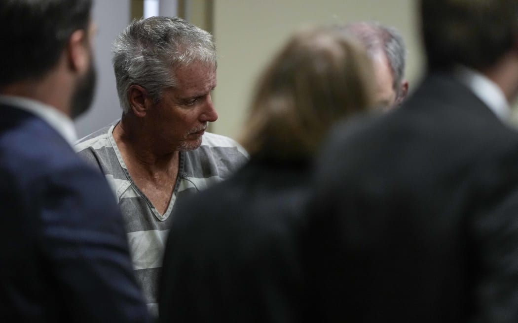 WINDER, GEORGIA - SEPTEMBER 6: Colin Gray, 54, the father of Apalachee High School shooting suspect Colt Gray, 14, enters the Barrow County courthouse for his first appearance, on September 6, 2024, in Winder, Georgia. Colin Gray is being charged with involuntary manslaughter, second-degree murder and cruelty to children after his son opened fire and killed 4 at the high school on Wednesday.   Brynn Anderson-Pool/Getty Images/AFP (Photo by POOL / GETTY IMAGES NORTH AMERICA / Getty Images via AFP)